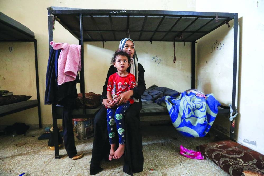 Displaced Palestinians, who fled their houses due to Israeli strikes, take shelter, amid the ongoing conflict, in Khan Younis in the southern Gaza Strip.