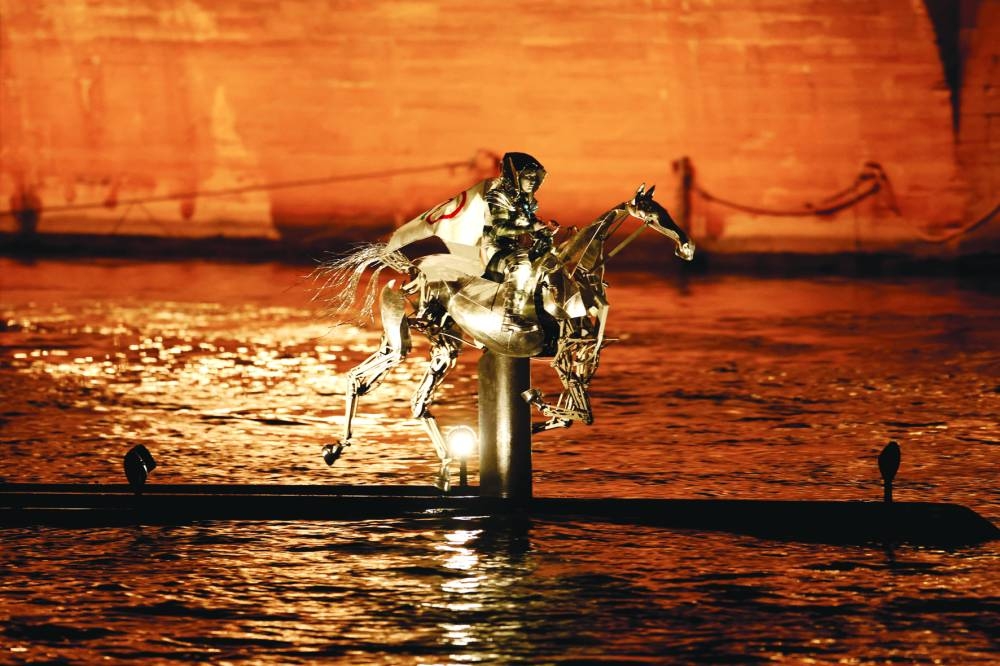A performer rides a metal horse on the river Seine during the opening ceremony. (Reuters)