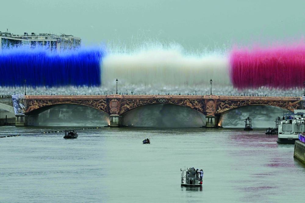 Fireworks in the French national colours explode over Pont d'Austerlitz during the opening ceremony of the Paris 2024 Olympic Games in Paris on Friday. (AFP)