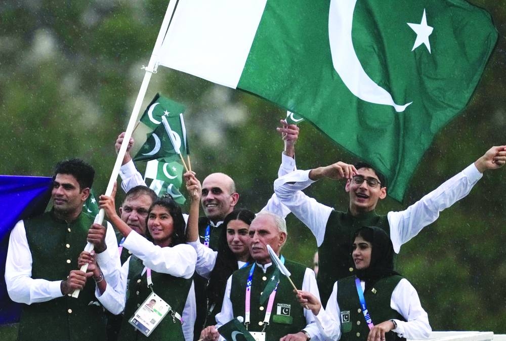 Athletes of Pakistan aboard a boat in the floating parade on the river Seine during the opening ceremony. (Reuters)