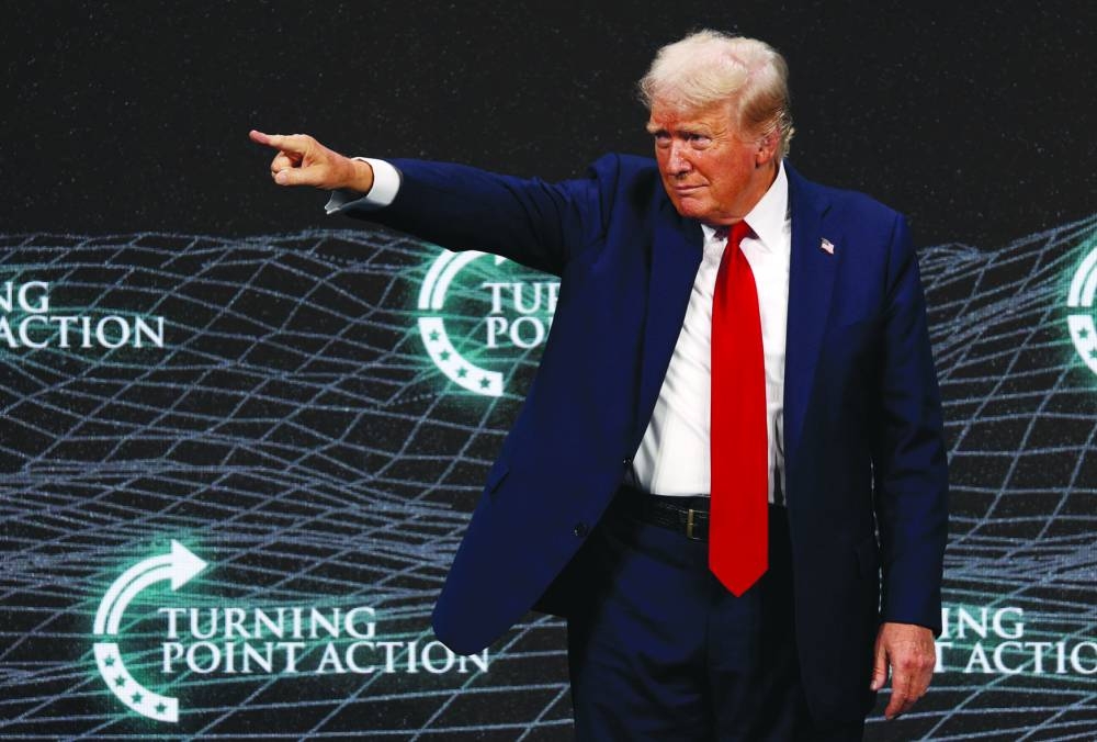 Former US president Donald Trump gestures on the stage at Turning Point Action’s The Believers Summit 2024 in West Palm Beach, Florida. (Reuters)