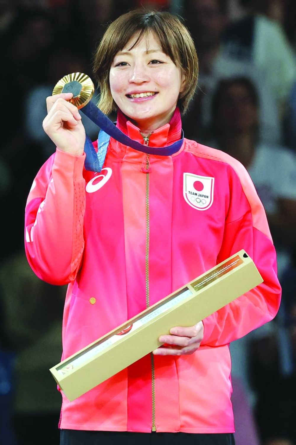 Gold medallist Japan's Natsumi Tsunoda celebrates on the podium for the judo women's 48kg of the Paris 2024 Olympic Games at the Champ-de-Mars Arena, in Paris on Saturday. (Photo by Jack GUEZ / AFP)