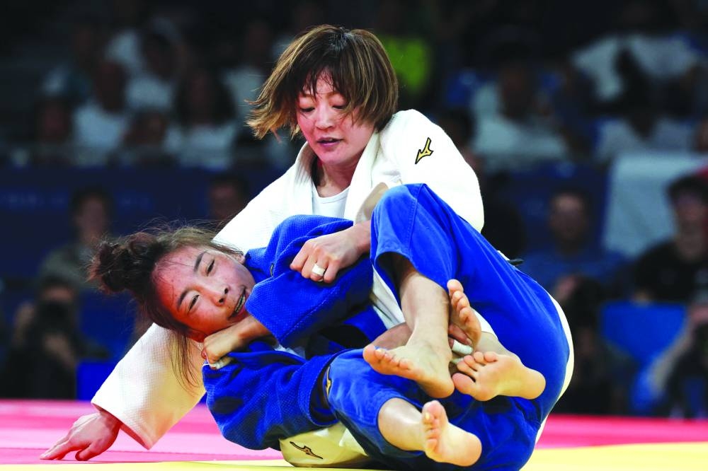 Japan’s Natsumi Tsunoda (in white) and Mongolia’s Baasankhuu Bavuudorj compete during the women’s 48kg gold medal bout of the Paris 2024 Olympic Games at the Champ-de-Mars Arena, in Paris on Saturday. (AFP) 