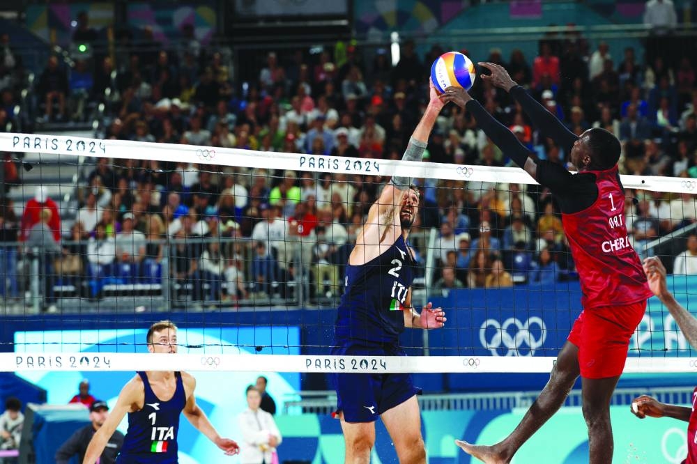 Paolo Nicolai of Italy and Samuele Cottafava of Italy in action against Cherif Younousse of Qatar on Saturday. (Reuters)