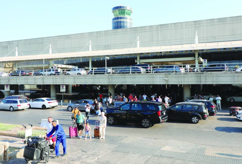 People push their luggage outside the Beirut-Rafic Hariri International Airport, in Lebanon, yesterday.