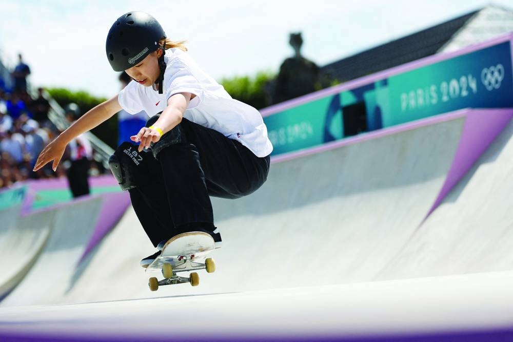 
Japan’s Coco Yoshizawa competes in the women’s street skateboarding prelims during the Paris 2024 Olympic Games at La Concorde yesterday. Right: Gold medallist Yoshizawa celebrates on the podium with silver medallist Liz Akama of Japan and bronze medallist Rayssa Leal of Brazil. (AFP/Reuters)  