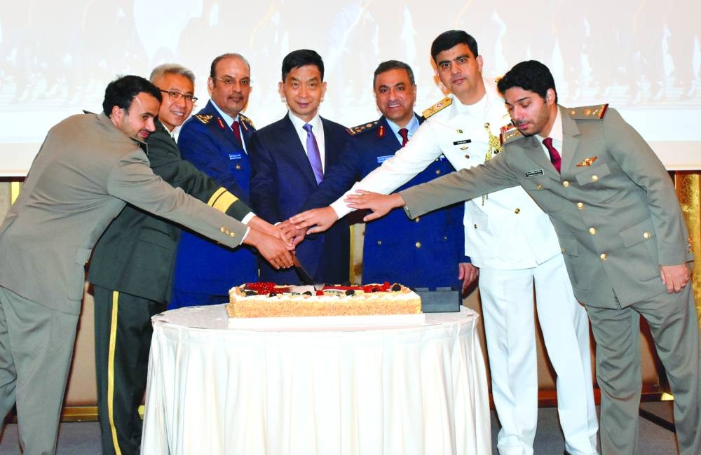 
Chinese ambassador Cao Xiaolin and defence attaché Senior Colonel Yang Yongzhi are joined by other dignitaries in cutting a ceremonial cake on the occasion. PICTURES: Thajudheen 