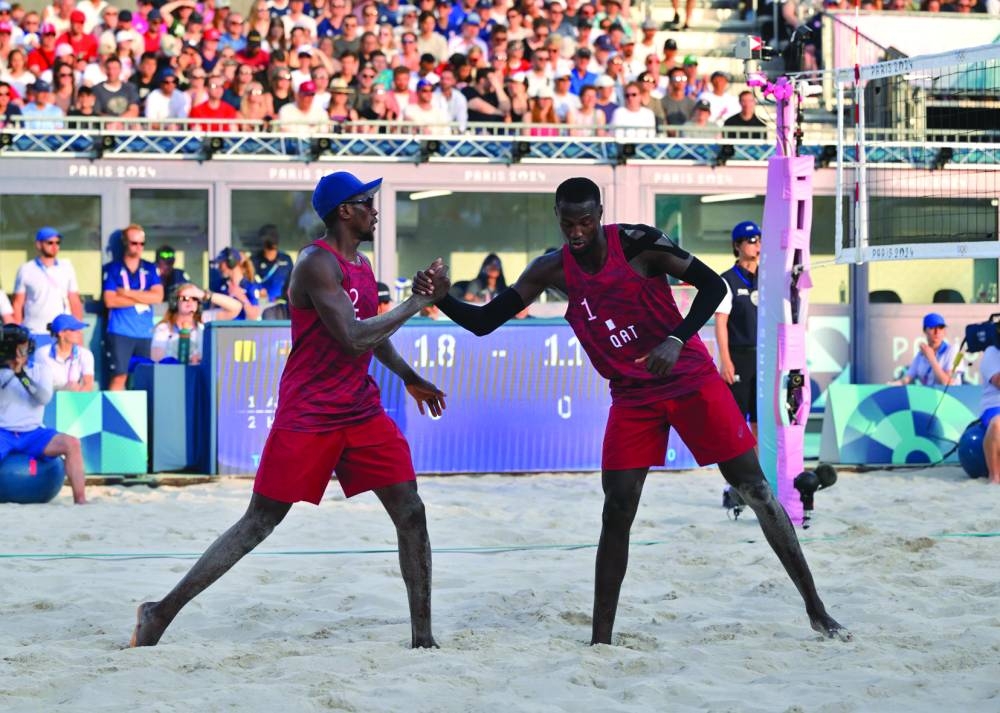 
Qatar’s Cherif Younousse and Ahmed Tijan celebrate after winning a point. 
