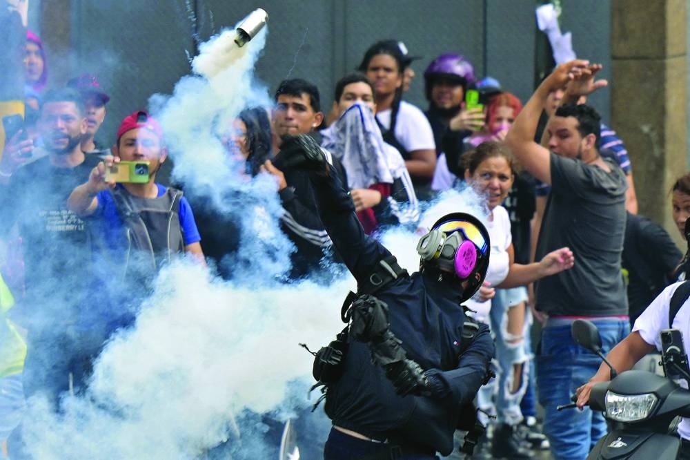 Opponents of Maduro’s government clash with police in Caracas neighbourhood. – AFP