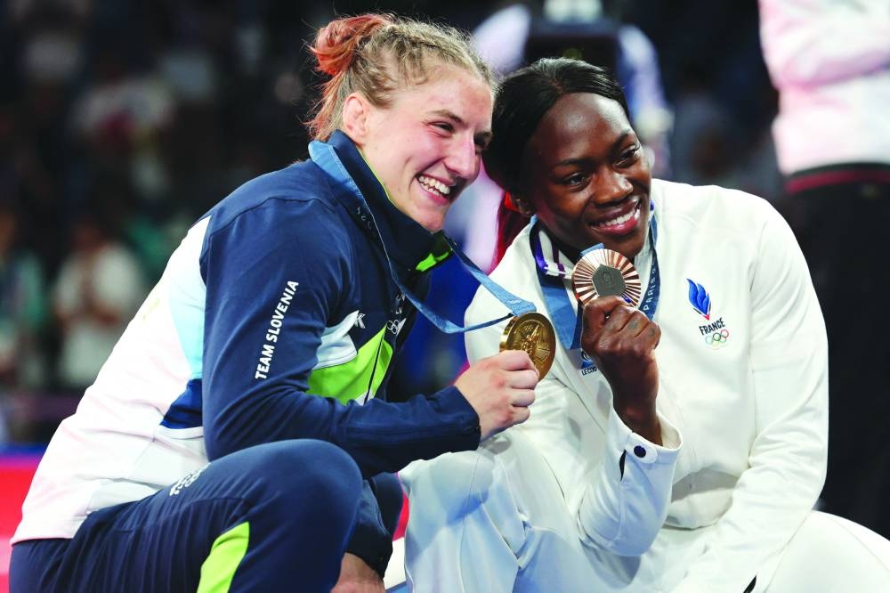 Gold medallist Slovenia’s Andreja Leski and bronze medallist France’s Clarisse Agbegnenou pose after the podium after the judo women’s -63kg of the Paris 2024 Olympic Games at the Champ-de-Mars Arena, in Paris yesterday. (AFP) 