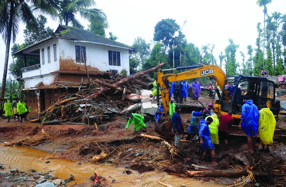 Rescuers search for survivors at a landslide site after multiple landslides in the hills in Wayanad on Tuesday. (Reuters)