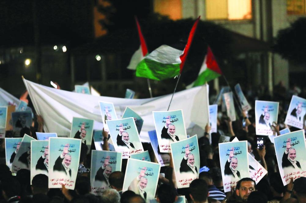 
People protest following the assassination of Hamas leader Ismail Haniyeh in Iran, in Amman, Jordan, yesterday. 
