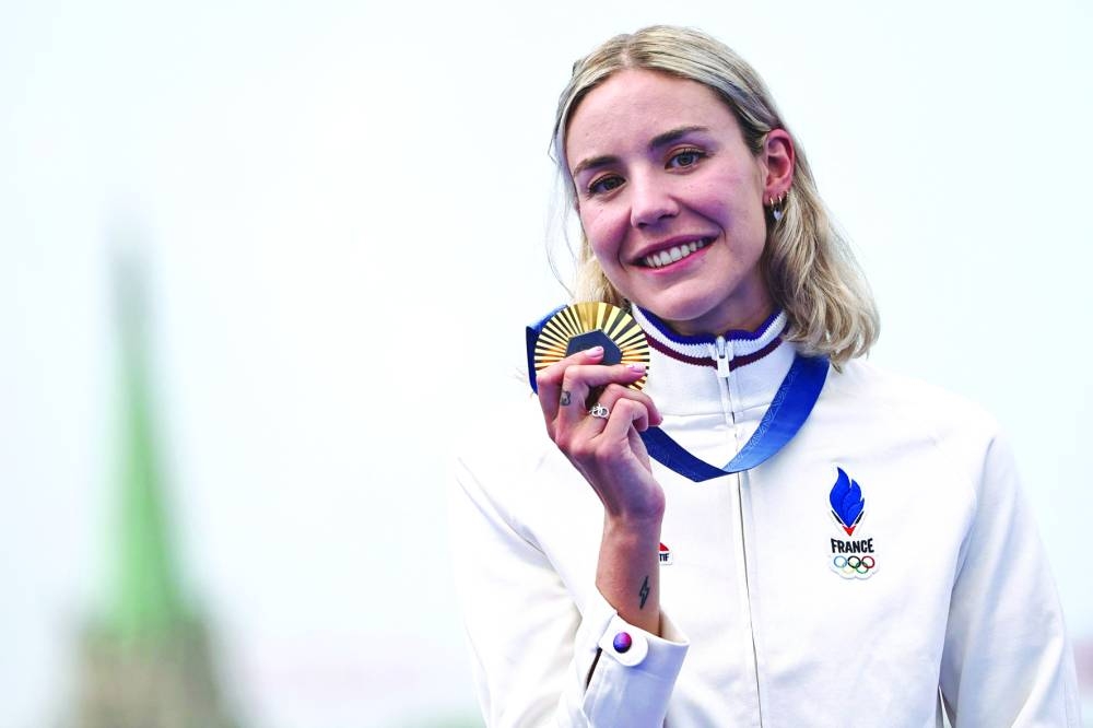 Gold medallist France’s Cassandre Beaugrand reacts on the women’s individual triathlon podium at the Paris 2024 Olympic on Wednesday. (AFP) 