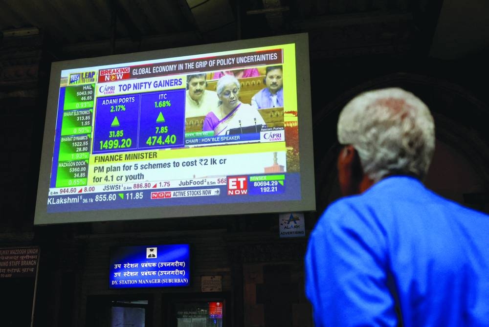 A man watches a screen displaying India’s Finance Minister Nirmala Sitharaman’s budget speech at a railway station in Mumbai, on July 23. 