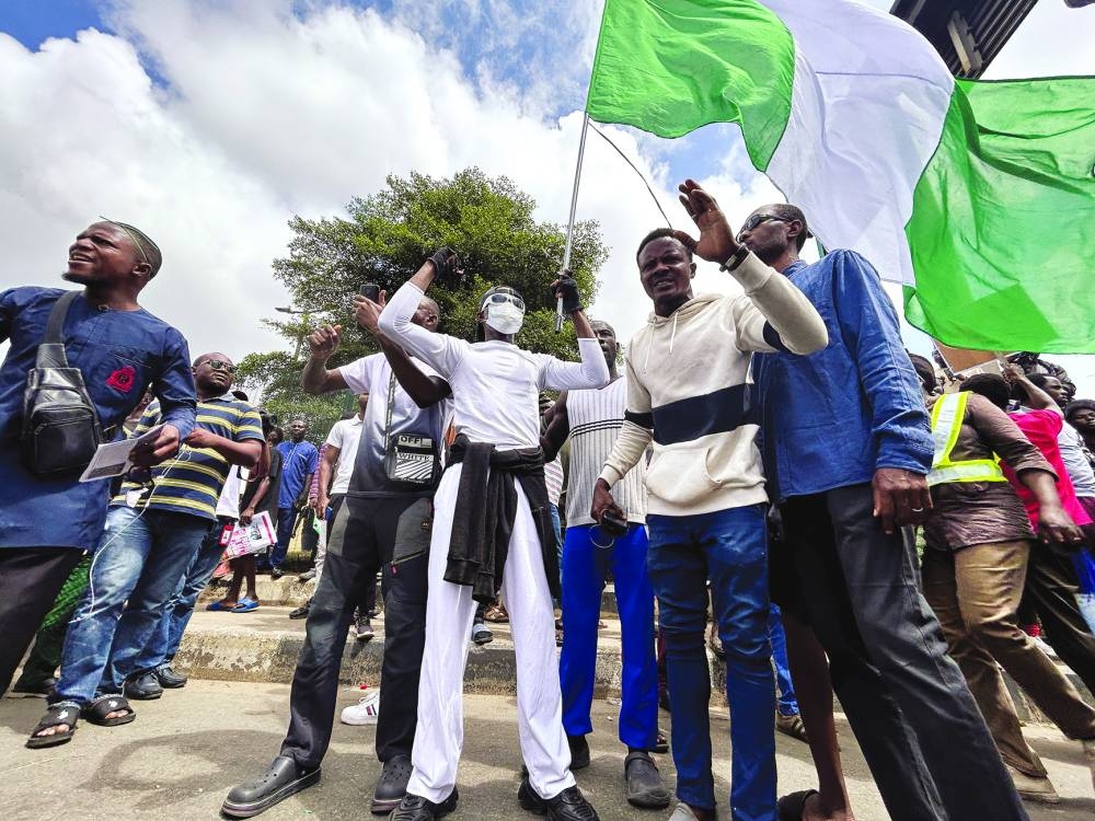 
A person holds a Nigerian national flag, as demonstrators gather for the second day to participate in an anti-government demonstration. 