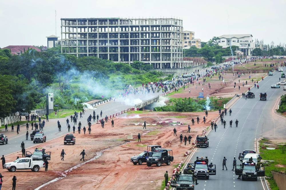 
A cloud of tear gas fired by Nigerian security forces lingers during the End Bad Governance protest in Abuja yesterday. 