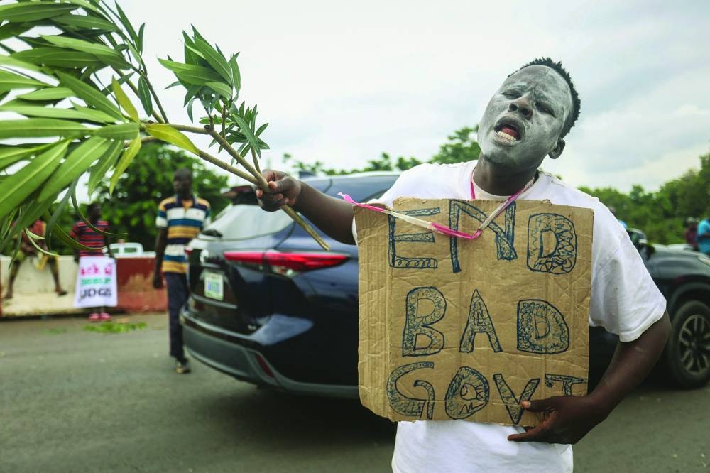 
A protester holds a placard during the End Bad Governance protest in Abuja. 
