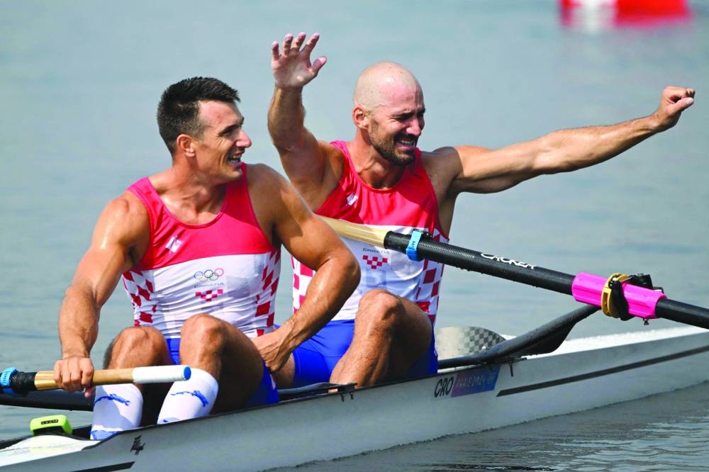 Croatia’s Martin Sinkovic (right) and Croatia’s Valent Sinkovic celebrate winning the gold medal in the men’s pair final rowing competition at Vaires-sur-Marne Nautical Centre in Vaires-sur-Marne during the Paris 2024 Olympic Games on Friday. (AFP) 