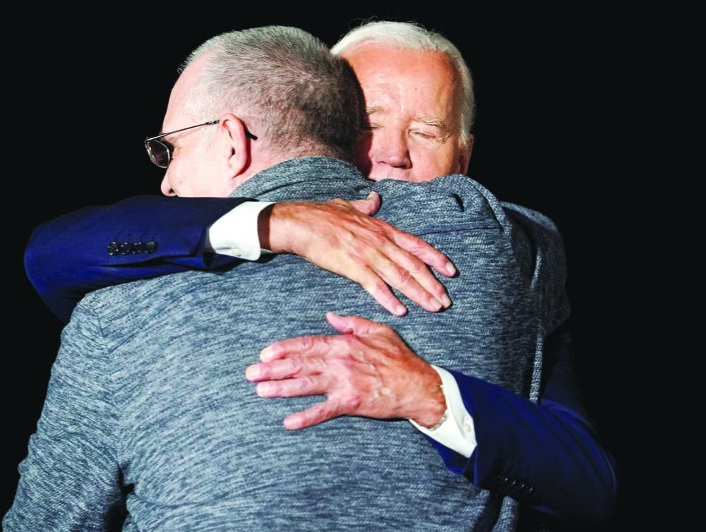 US President Joe Biden greets Evan Gershkovich, who was released from detention in Russia, upon his arrival at Joint Base Andrews in Maryland, US. (Reuters)