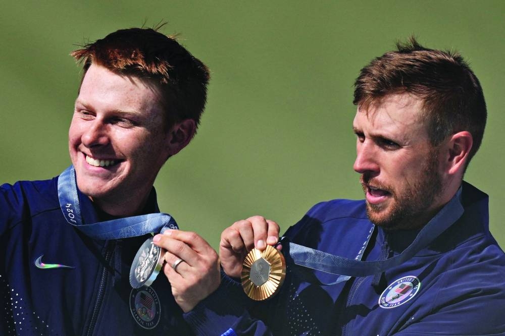 Skeet gold medallist Vincent Hancock (right) and silver medallist Conner Lynn Prince pose with their medals on Saturday. (Reuters)
