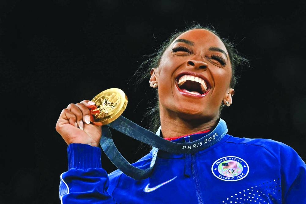 Simone Biles of the United States celebrates with her gold medal after winning the women’s vault event during the Paris Olympic Games at the Bercy Arena on Saturday. (AFP) 