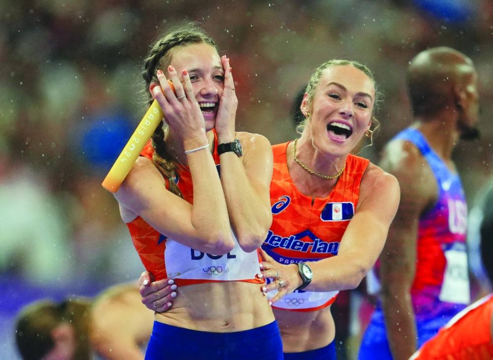 Femke Bol (left) celebrates with teammate Lieke Klaver after guiding Netherlands to 4x400m relay mixed gold at the Stade de France. (Reuters) 