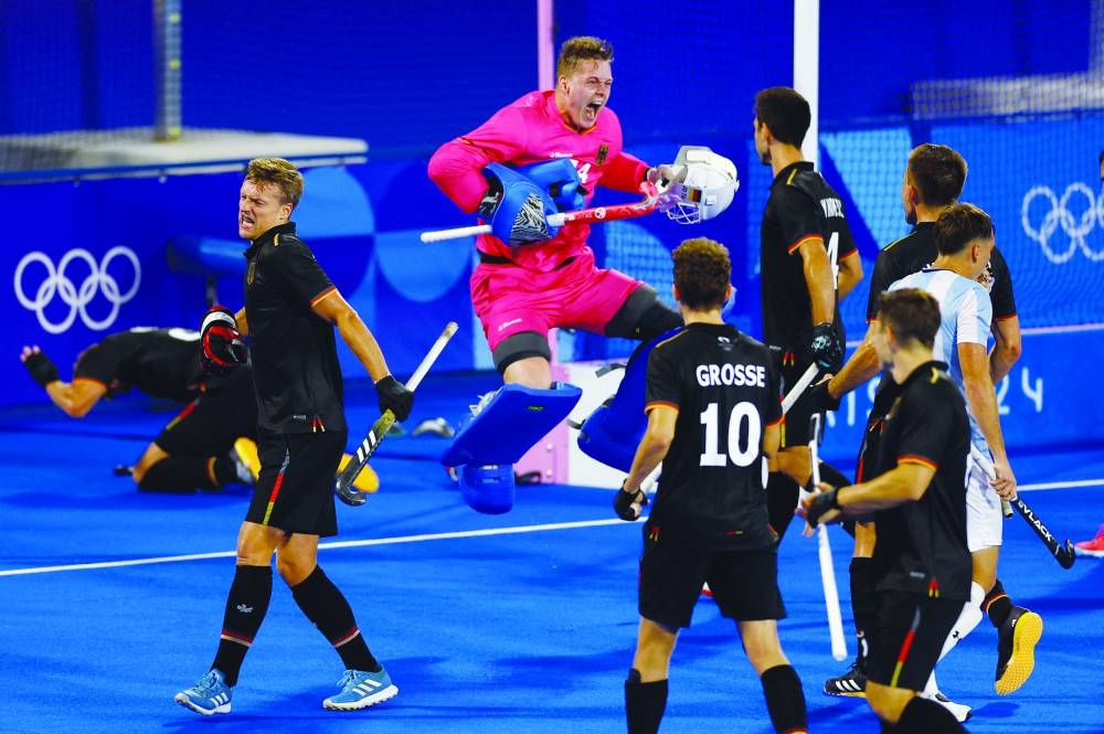 
Germany’s Jean-Paul Danneberg and Johannes Grosse celebrate with teammates after winning the hockey quarter-final against Argentina at Yves-du-Manoir Stadium, Colombes, France, yesterday. (Reuters) 