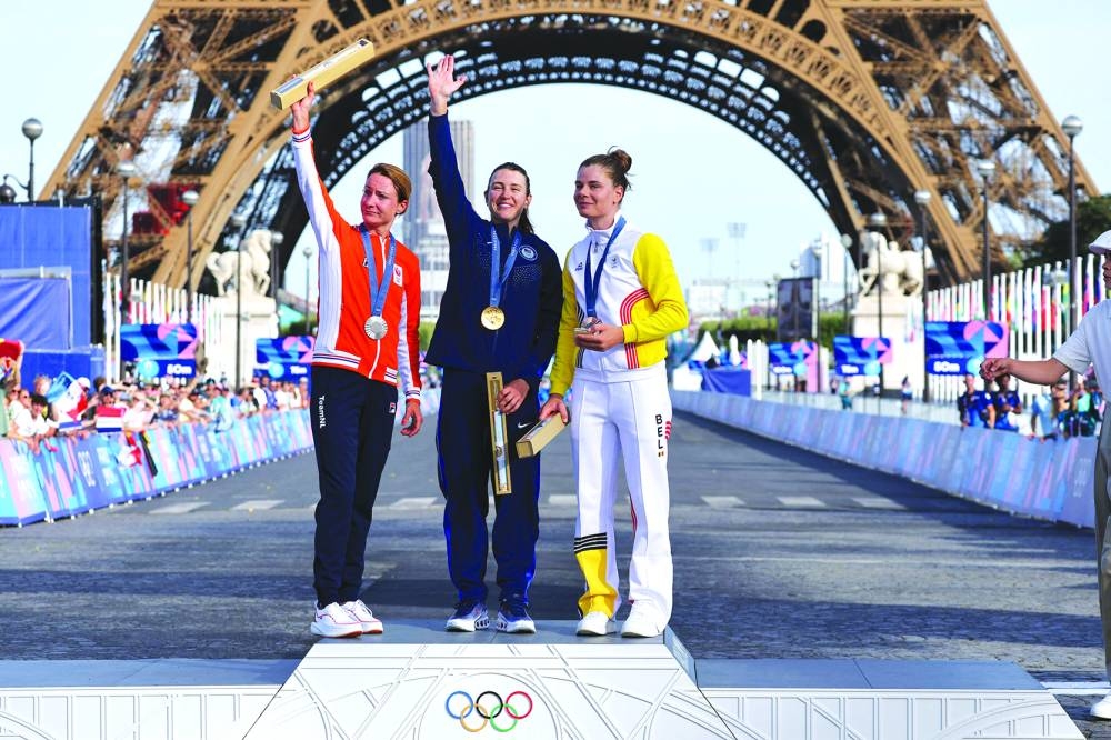 
Silver medallist Netherlands’ Marianne Vos (left), gold medallist US’ Kristen Faulkner and bronze medallist Belgium’s Lotte Kopecky (right) celebrate on the women’s cycling road race podium during the Paris 2024 Olympic Games in Paris yesterday. (AFP) 