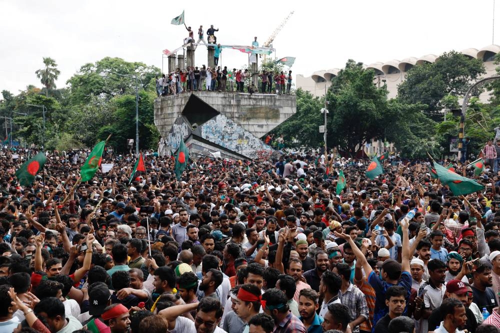 People celebrate the resignation of Bangladeshi Prime Minister Sheikh Hasina in Dhaka, Bangladesh. REUTERS