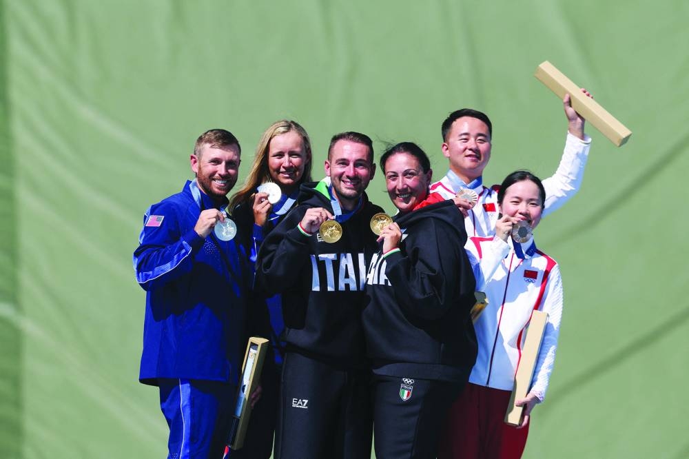 FROM LEFT: Silver medallists US’ Austen Jewell Smith and Vincent Hancock, gold medallists Italy’s Diana Bacosi and Gabriele Rossetti and bronze medallist China’s Jiang Yiting and Lyu Jianlin pose on the Skeet Mixed Team podium during the Paris 2024 Olympic Games at Chateauroux Shooting Centre on Monday. (AFP)