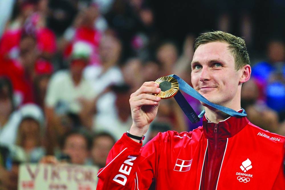 Denmark's gold medallist Viktor Axelsen celebrates after winning badminton gold medal during the Paris 2024 Olympic Games at Porte de la Chapelle Arena in Paris on Monday. (AFP)