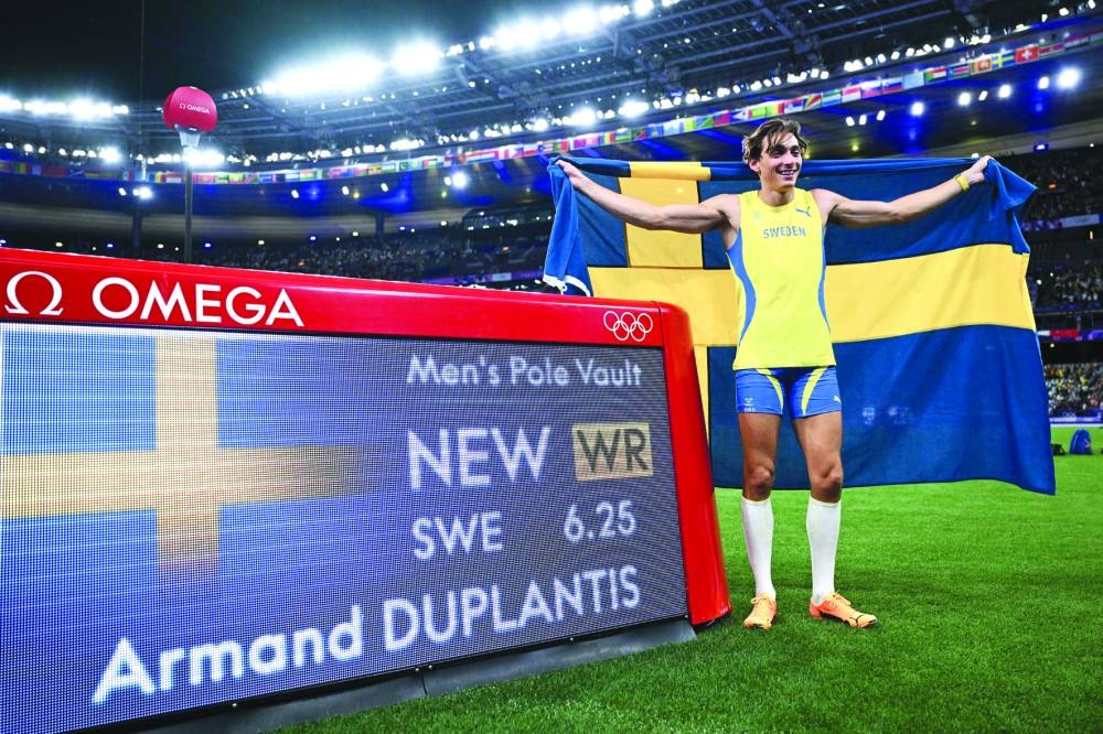 Winner Sweden’s Armand Duplantis celebrates setting the new men’s pole vault world record at the Paris 2024 Olympic Games at Stade de France in Saint-Denis, north of Paris, yesterday. (AFP) 