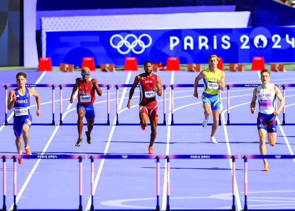 Qatar’s Abderrahman Samba (centre) competes during the the 400m hurdles heat at the Paris Olympic Games yesterday. (AFP) 