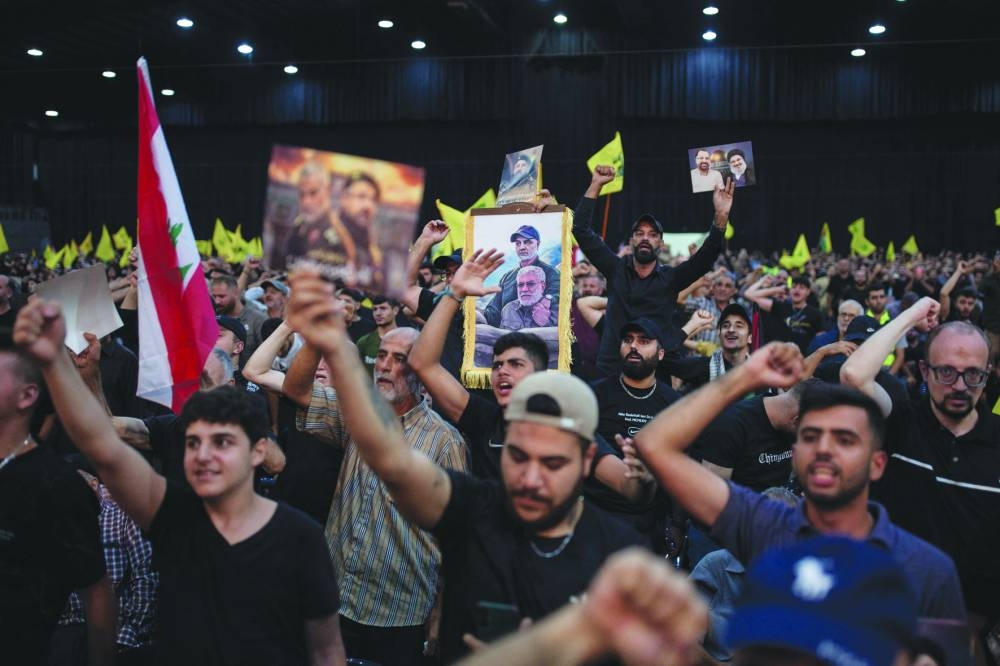 
Supporters shout slogans before the speech of Hezbollah leader in Beirut. 
