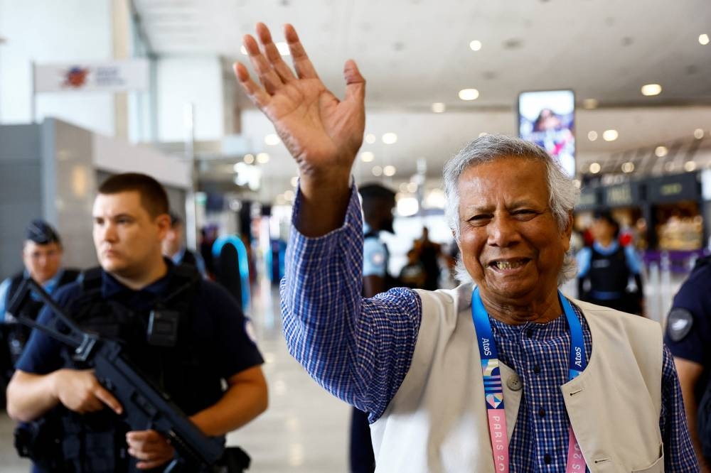 Nobel laureate Muhammad Yunus, who was recommended by Bangladeshi student leaders as the head of the interim government in Bangladesh, waves at Paris Charles de Gaulle airport in Roissy-en-France, France Wednesday. REUTERS