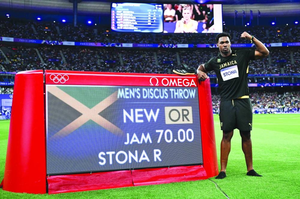 
Jamaica’s Roje Stona celebrates winning the men’s discus throw final and setting the new Olympic record on Wednesday. (AFP) 