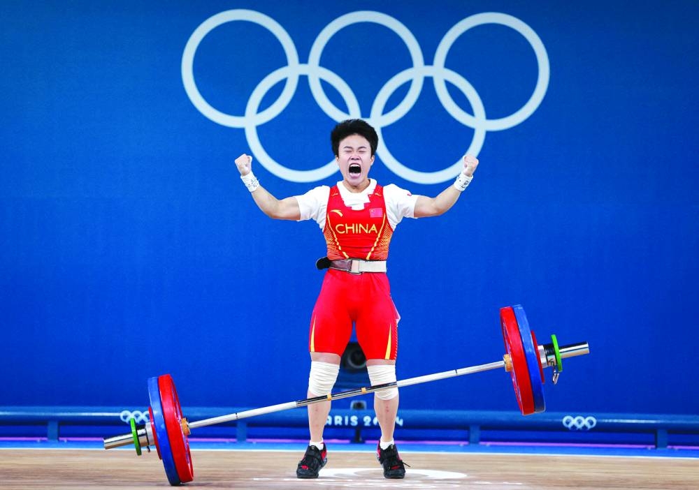 Hou Zhihui of China reacts after winning gold in the women’s 49kg weightlifting at the Paris Olympics on Wednesday. (Reuters)
