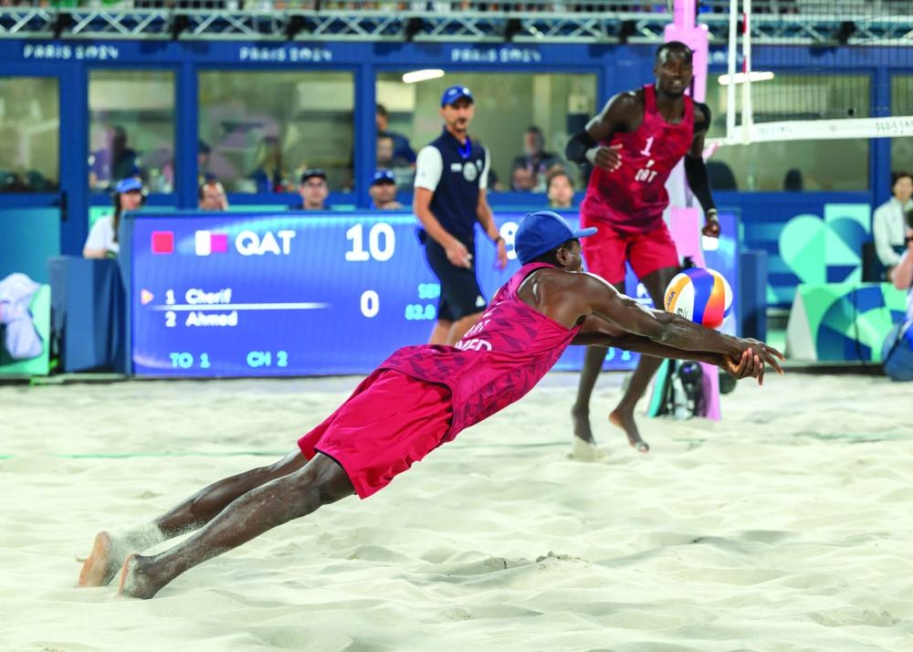 Qatar’s Cherif Younousse (left) dives to retrieve the ball as teammate Ahmed Tijan looks on during their Paris 2024 Olympic Games beach volleyball quarter-final against USA’s Miles Partain and Andrew Benesh at the Eiffel Tower Stadium on Wednesday.