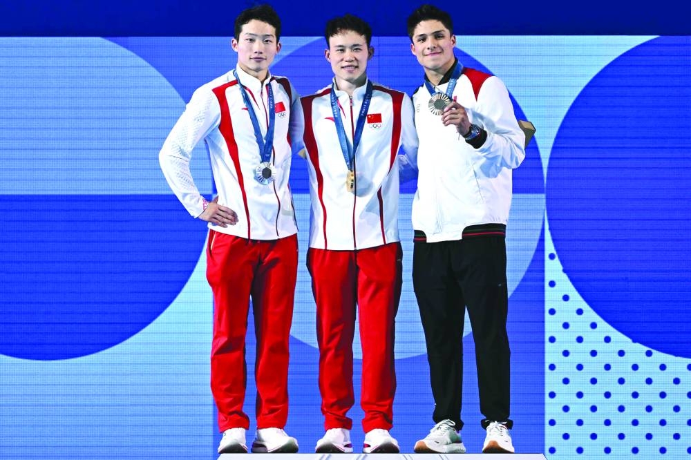 FROM LEFT: Silver medallist China’s Wang Zongyuan, gold medallist China’s Xie Siyi and bronze medallist Mexico’s Osmar Olvera Ibarra stand on the podium after the men’s 3m springboard diving final during the Paris 2024 Olympic Games at the Aquatics Centre in Saint-Denis, north of Paris, on Thursday. (AFP)