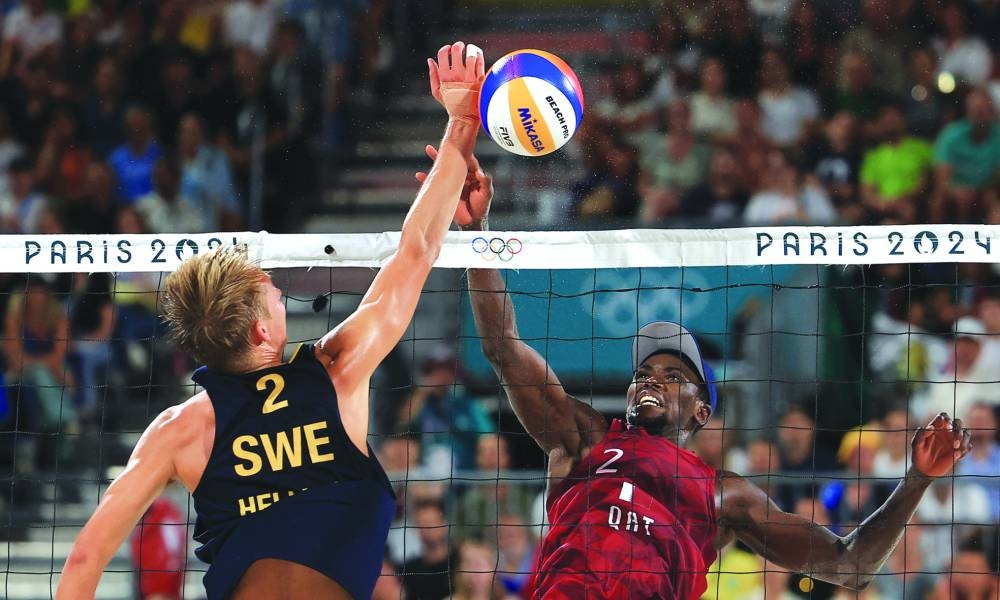 Ahmed Tijan (right) of Qatar and Jonatan Hellvig of Sweden in action during the beach volleyball semi-final during the Paris Olympics at the Eiffel Tower Stadium on Thursday. (Reuters)