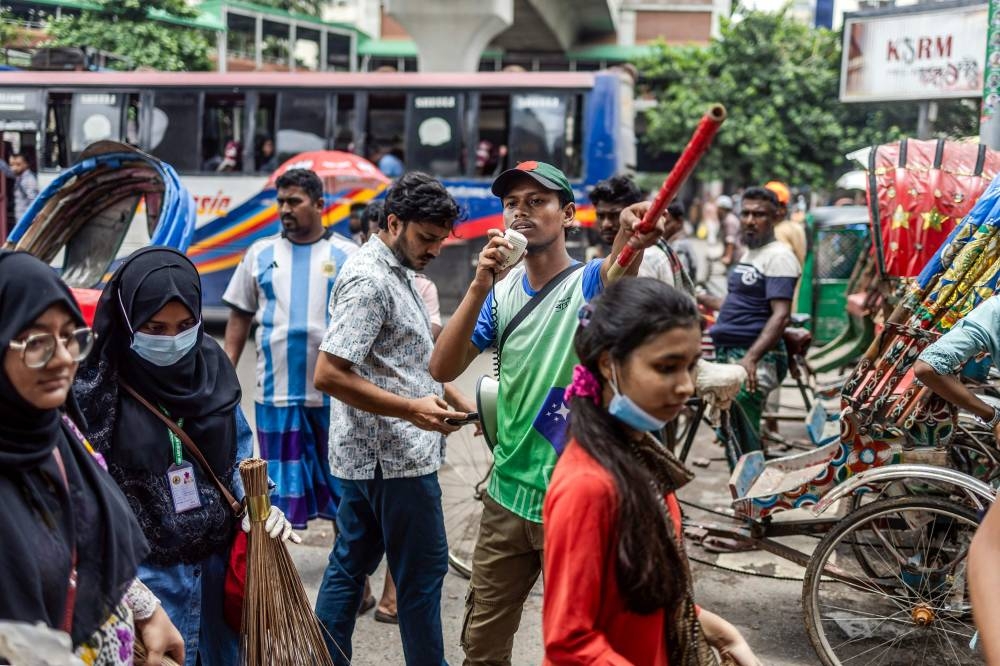 Bangladeshi students control the traffic as police went on strike in Dhaka on Friday. AFP