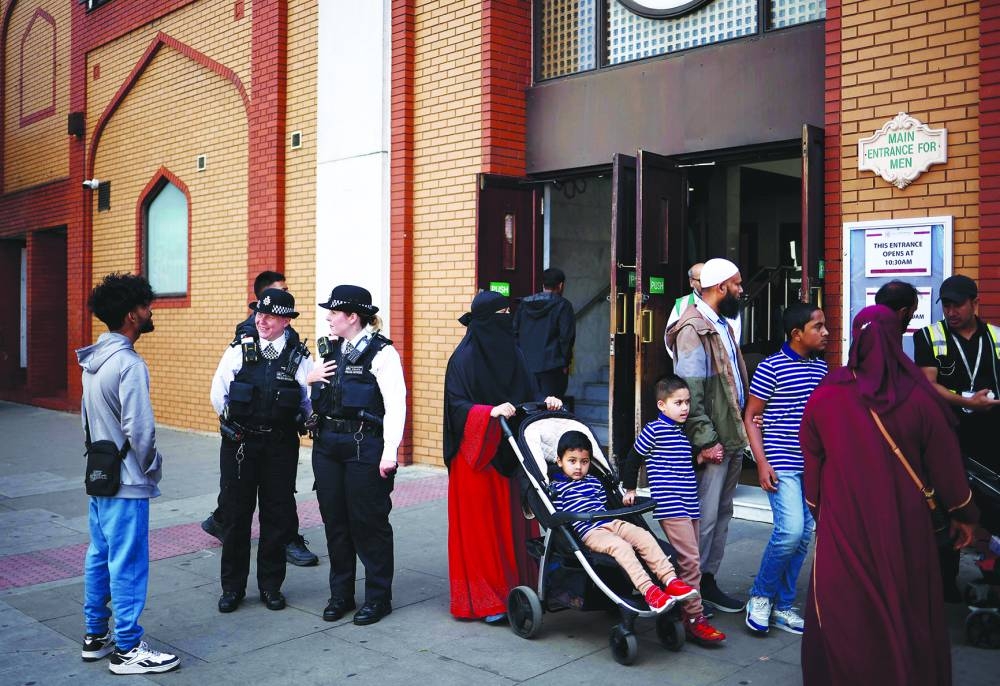 Police officers stand guard at the East London Mosque in Tower Hamlets.
