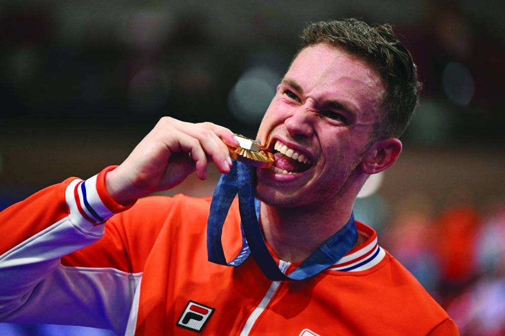 Gold medallist Netherlands’ Harrie Lavreysen poses with his medal  on the podium of the men’s track cycling sprint event of the Paris 2024 Olympic Games at the Saint-Quentin-en-Yvelines National Velodrome in Montigny-le-Bretonneux, south-west of Paris, on Friday. (AFP)