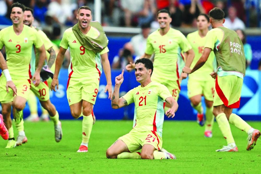 Spain’s forward Sergio Camello celebrates with teammates scoring his team’s fourth goal in the final against France during the Paris 2024 Olympic Games on Friday. (AFP) 