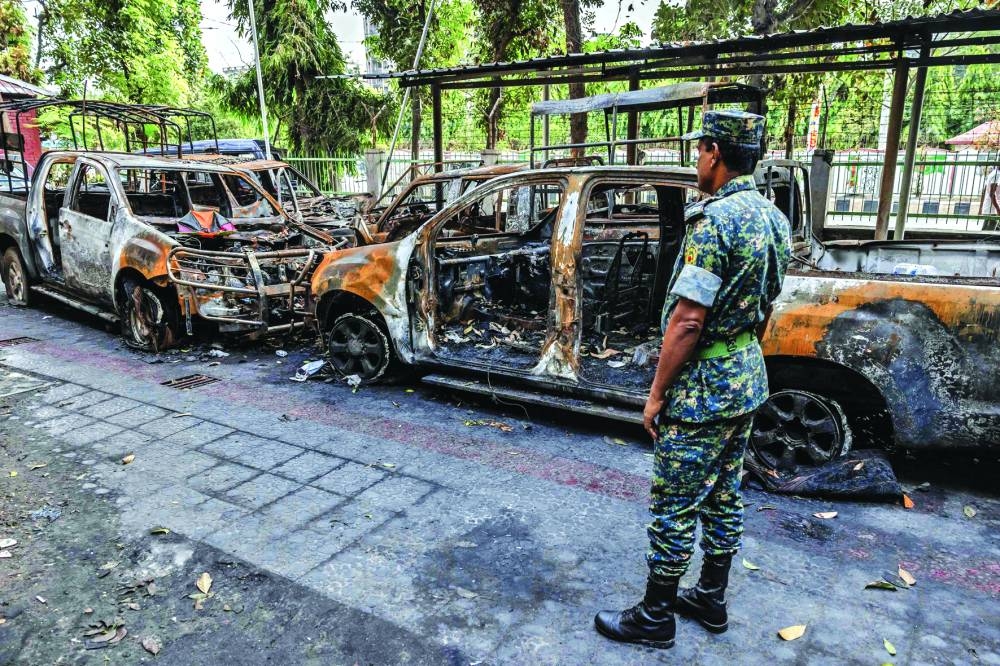 
A member of the Bangladesh Army assesses the damages inside a police station vandalised and burned by protesters. 