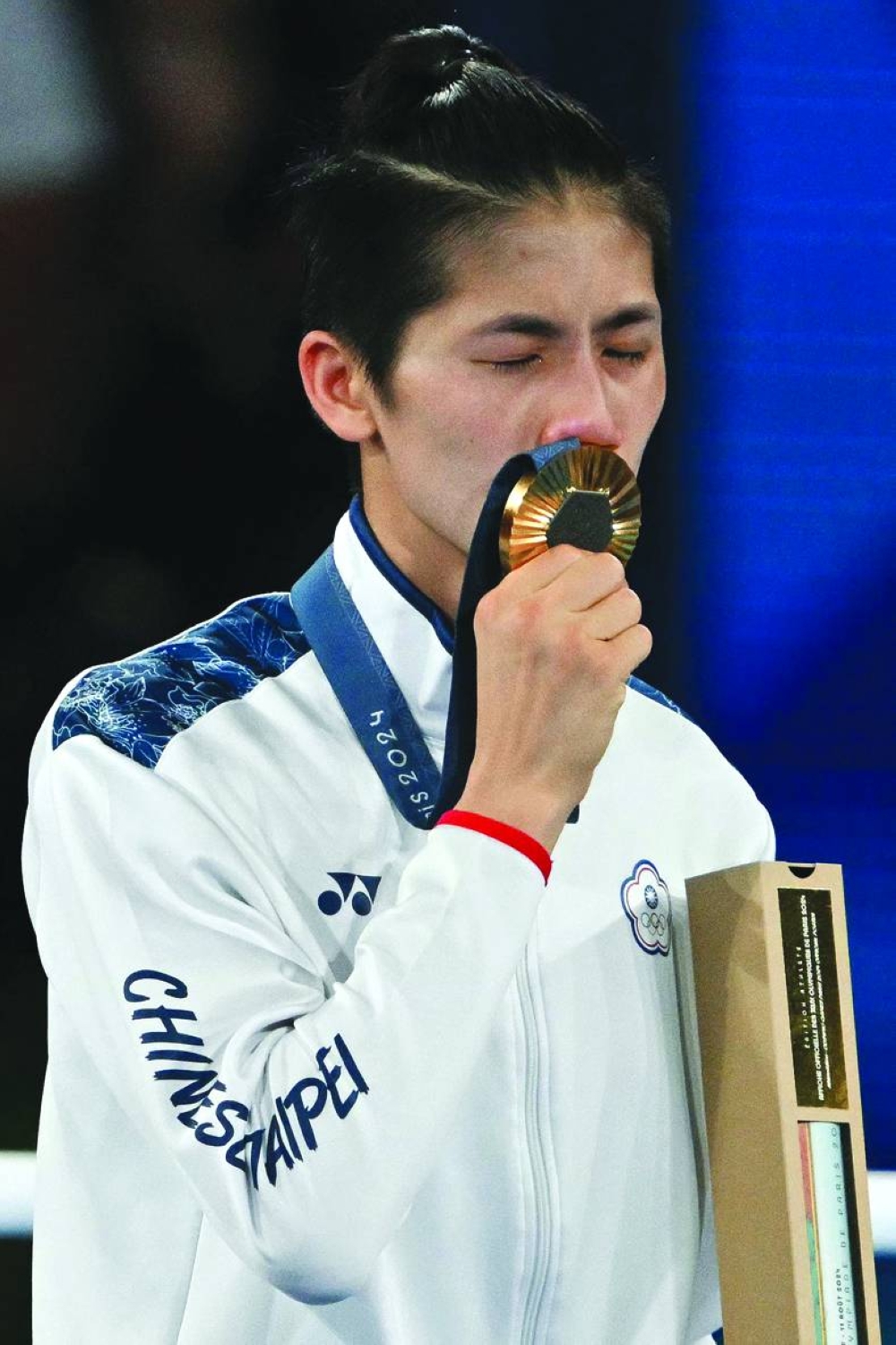 Gold medallist Taiwan’s Lin Yu-ting celebrates on the podium during the medal ceremony for the women’s 57kg category on Saturday. (AFP)