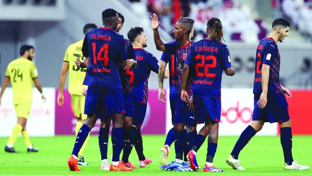 Kenyan striker Michael Olunga (left) celebrates one of his three goals for Al Duhail in their Qatar Stars League match against Qatar SC at Khalifa International Stadium in Doha on Saturday. 
