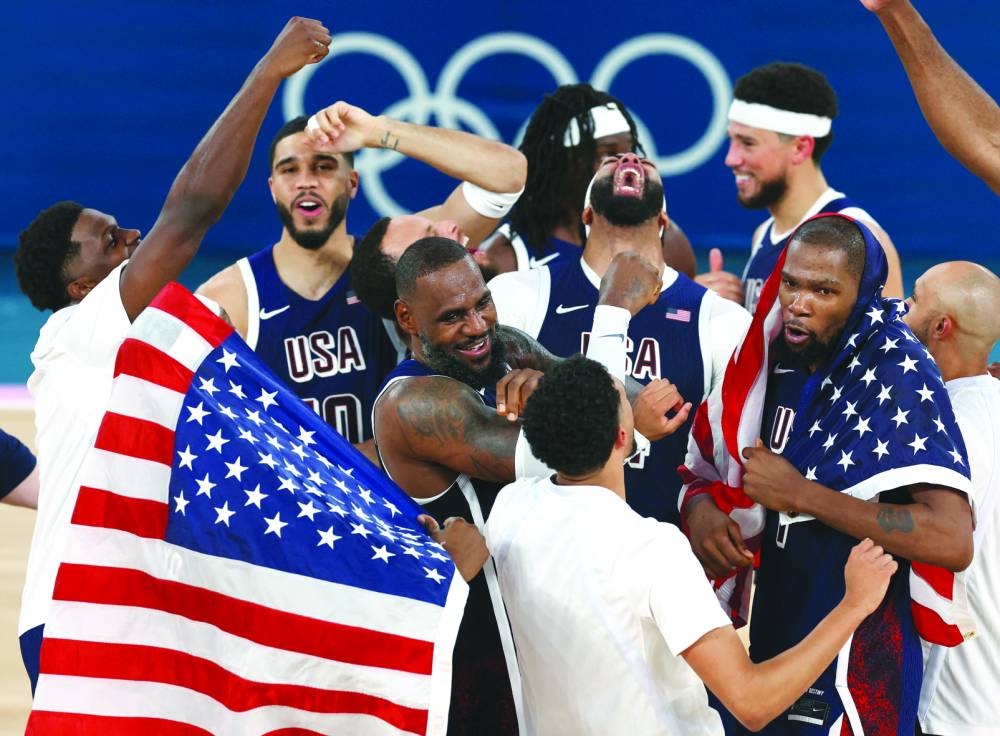 Lebron James of United States celebrates with teammates after they win the gold medal clash in the basketball final of the Paris 2024 Olympics at Bercy Arena, Paris, France, on Saturday. (Reuters)