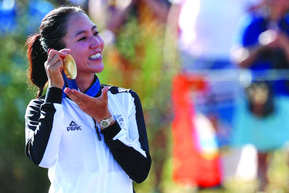 New Zealand's gold medallist Lydia Ko poses with her medal on the podium during the women golf individual stroke play medal ceremony of the Paris 2024 Olympic Games at Le Golf National in Guyancourt, south-west of Paris, on Saturday. (AFP)
