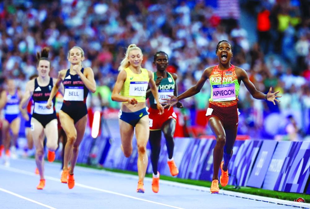 Faith Kipyegon of Kenya celebrates after winning the women’s 1,500m gold ahead of silver medallist Jessica Hull of Australia and bronze medallist Georgia Bell of Britain during the Paris Olympic Games at the Stade de France on Saturday. (Reuters) 